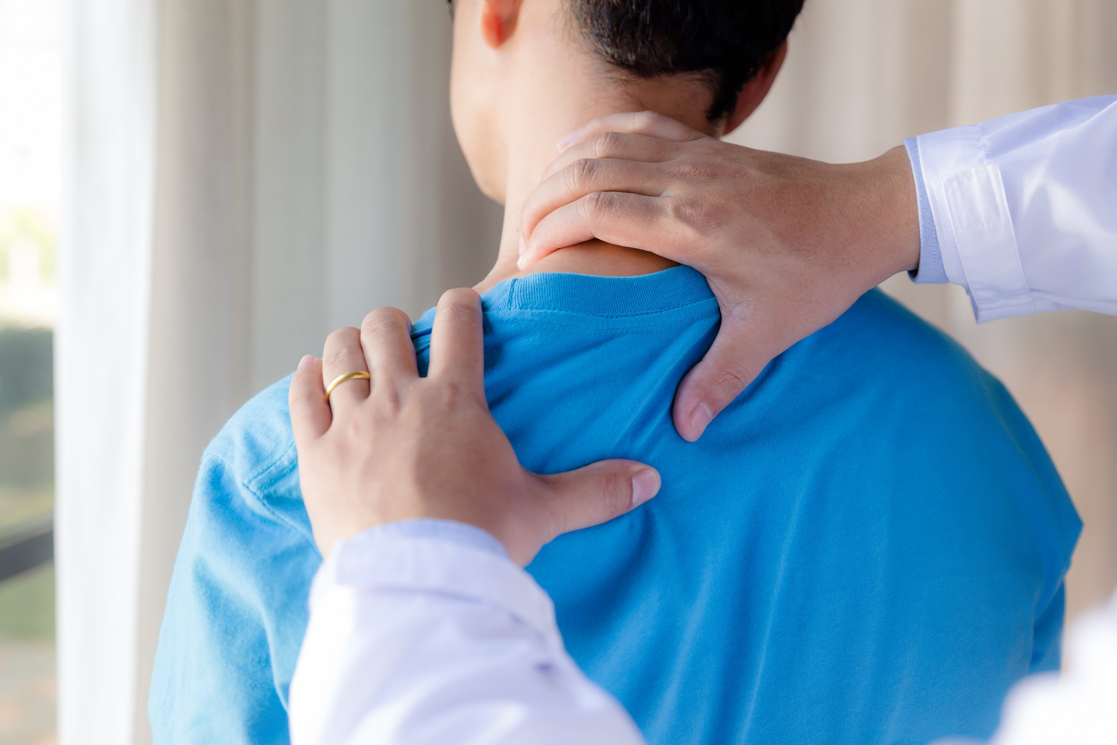 Modern rehabilitation physiotherapist with young man.