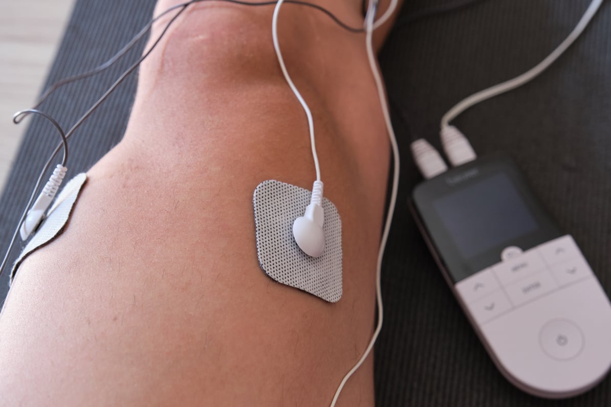 electrostimulation treatment, electrodes on a man's leg, ten