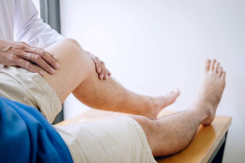 Doctor Physiotherapist Assisting a Male Patient 